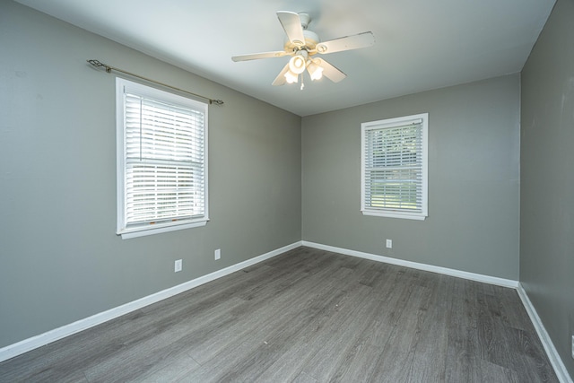 spare room with ceiling fan and dark hardwood / wood-style flooring