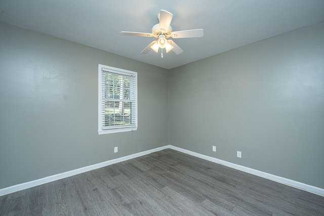 spare room featuring ceiling fan and dark hardwood / wood-style flooring