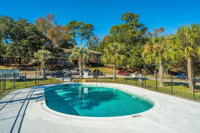 view of pool with a yard and a patio