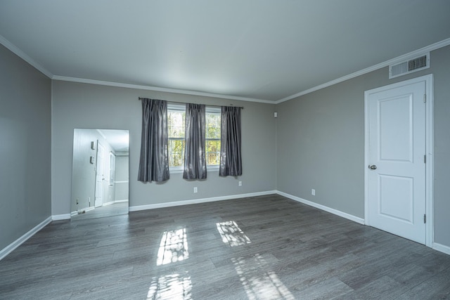 unfurnished room featuring dark hardwood / wood-style flooring and crown molding