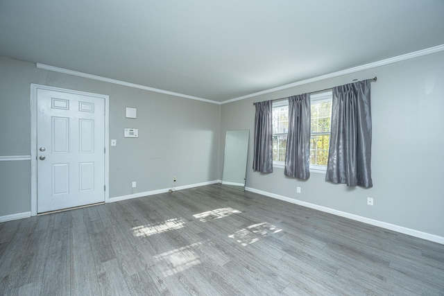 unfurnished room featuring wood-type flooring and ornamental molding