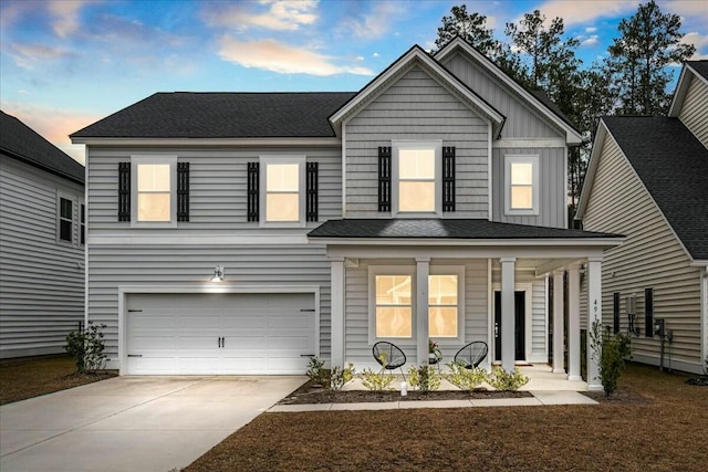 view of front of property with a garage and covered porch