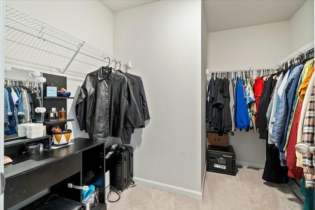 spacious closet featuring light carpet