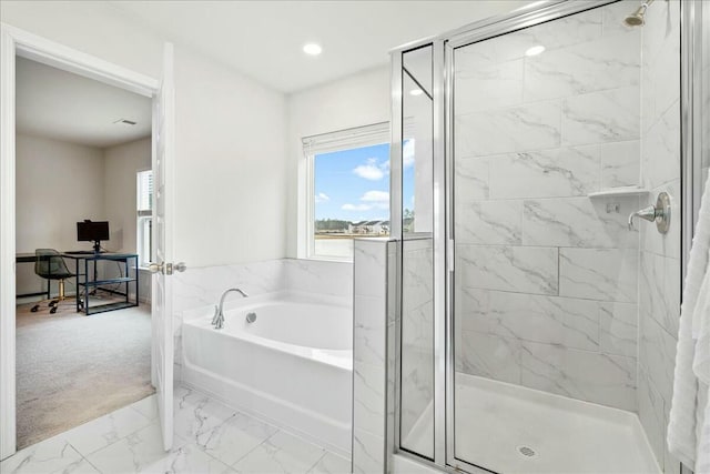 bathroom featuring independent shower and bath and a healthy amount of sunlight