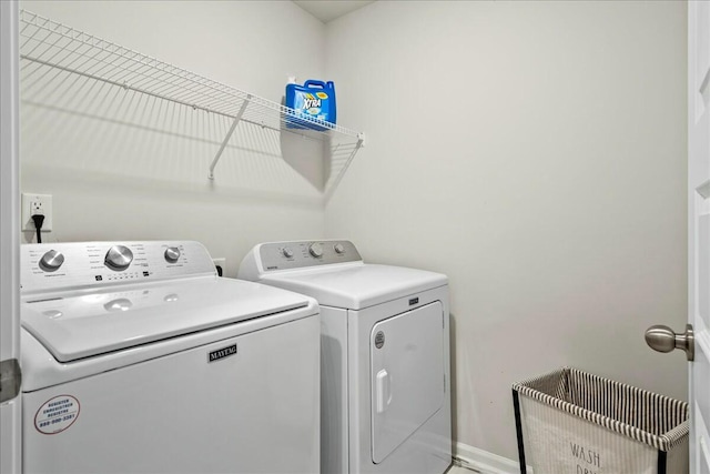 clothes washing area featuring separate washer and dryer