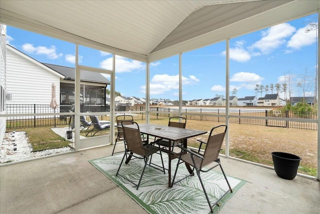 sunroom with vaulted ceiling and a wealth of natural light