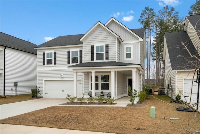 view of front of house with a garage and central AC