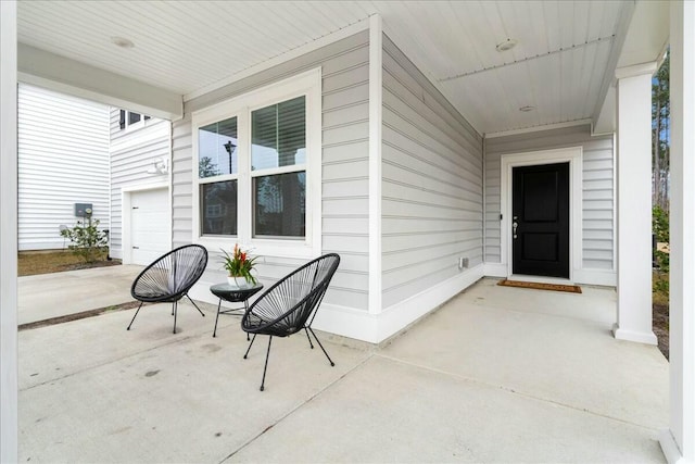 view of patio / terrace with a garage and covered porch