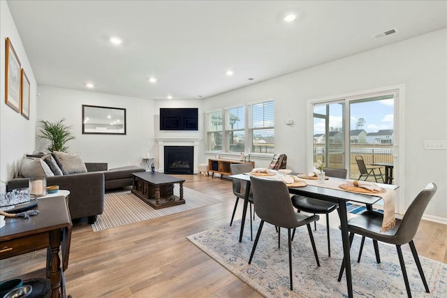 dining space with light hardwood / wood-style flooring