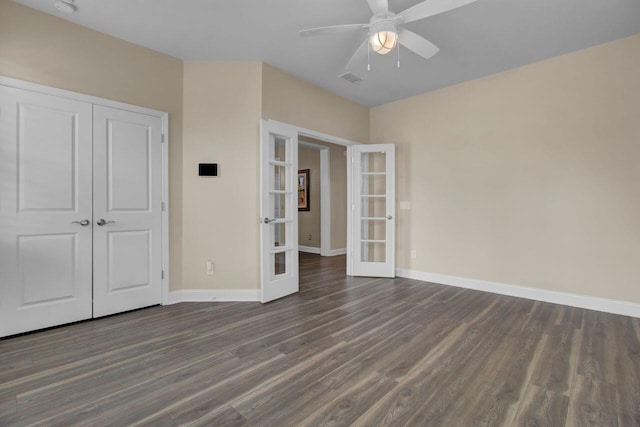 unfurnished bedroom with baseboards, a ceiling fan, dark wood-style floors, french doors, and a closet