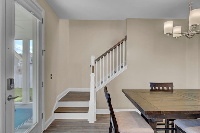 dining room featuring baseboards, plenty of natural light, stairway, and wood finished floors