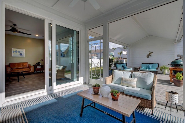 sunroom / solarium featuring lofted ceiling and ceiling fan