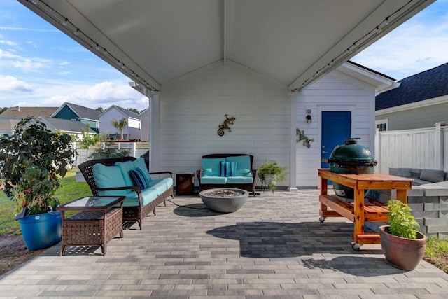 view of patio with a grill, fence, and an outdoor hangout area