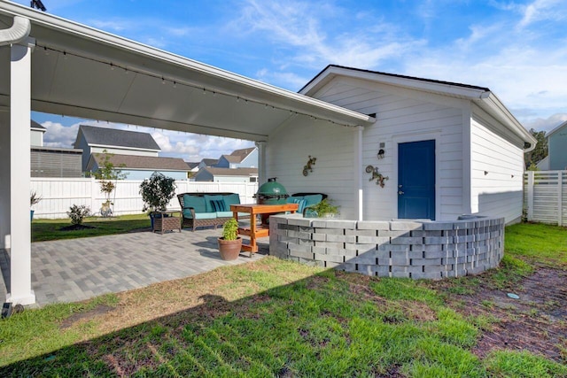 rear view of house featuring a patio, a yard, and fence