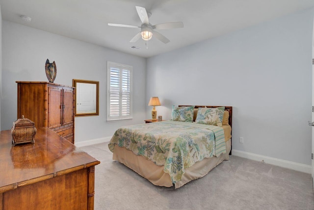 bedroom featuring a ceiling fan, light carpet, visible vents, and baseboards