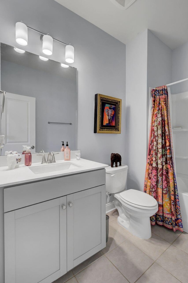 full bathroom featuring shower / bath combo, vanity, toilet, and tile patterned floors