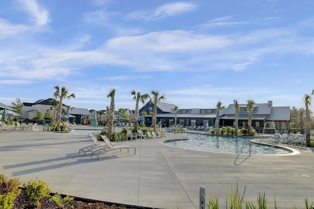 pool featuring a residential view and a patio