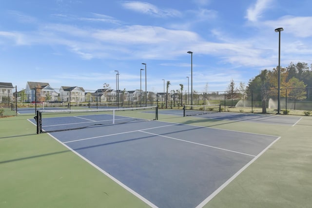 view of tennis court with fence