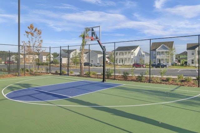 view of sport court with community basketball court, fence, and a residential view