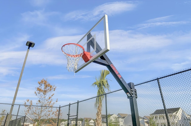 view of basketball court with fence