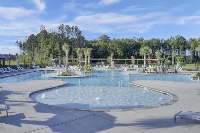 pool with a patio area and fence