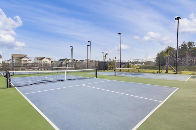 view of sport court with fence