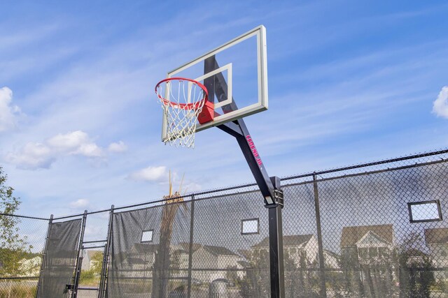 view of basketball court featuring fence