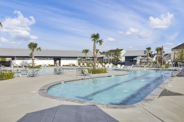 pool featuring a patio area and a residential view