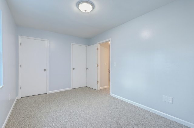 unfurnished bedroom featuring carpet floors and a closet