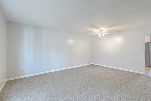 empty room with ceiling fan and carpet