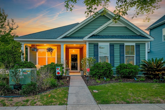 1589 Seabago Dr, Charleston, SC 29414 - view of front of home featuring a lawn, a porch, and roof with shingles