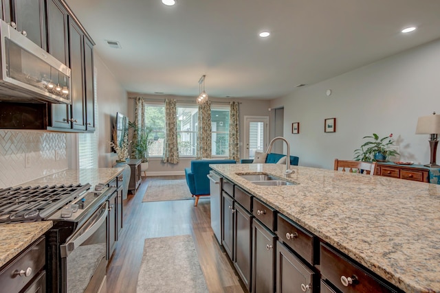 1589 Seabago Dr, Charleston, SC 29414 - kitchen featuring a sink, stainless steel appliances, wood finished floors, light stone countertops, and recessed lighting