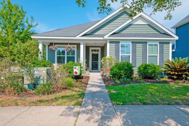 1589 Seabago Dr, Charleston, SC 29414 - bungalow-style home featuring roof with shingles, a front yard, and covered porch