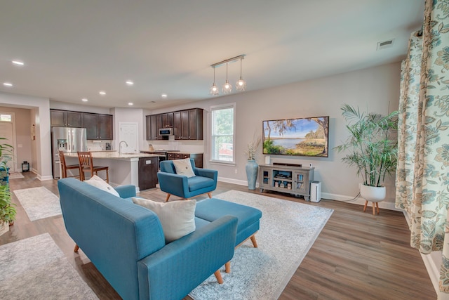 1589 Seabago Dr, Charleston, SC 29414 - living room featuring baseboards, recessed lighting, and light wood-style flooring