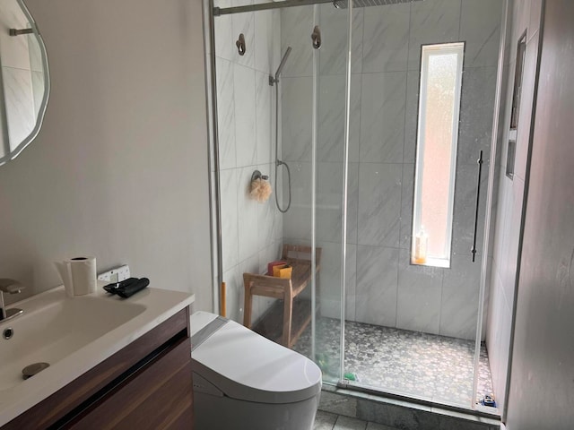 bathroom featuring a shower with door, vanity, toilet, and tile patterned flooring