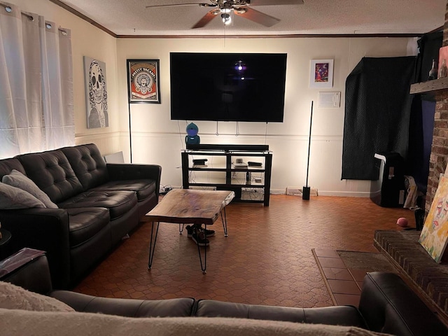 living room featuring crown molding, a textured ceiling, and ceiling fan