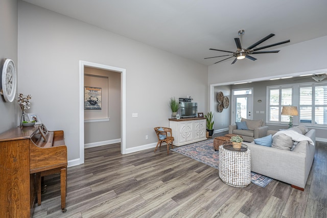 living room with hardwood / wood-style flooring and ceiling fan