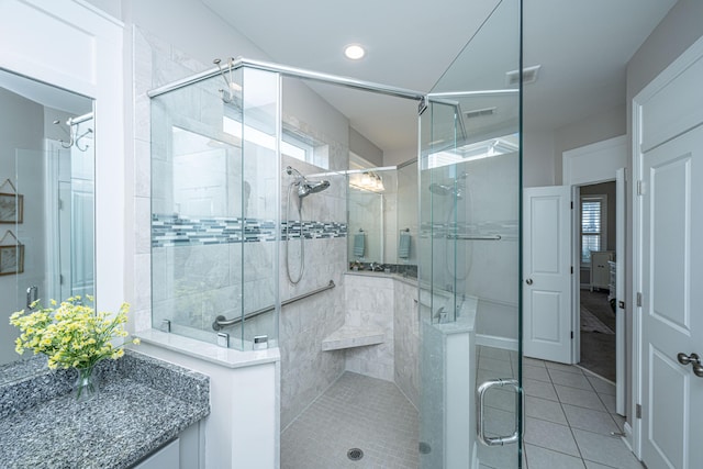 bathroom featuring a shower with shower door and tile patterned flooring