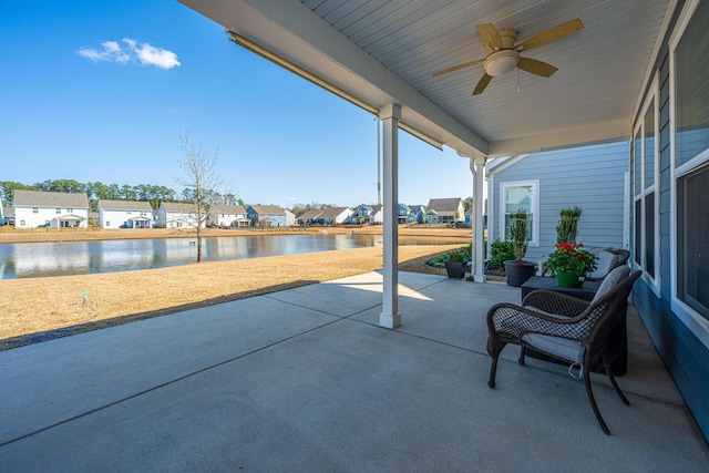 view of patio / terrace with a water view and ceiling fan