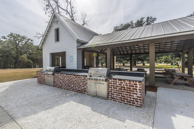 view of patio featuring area for grilling, a gazebo, and an outdoor kitchen