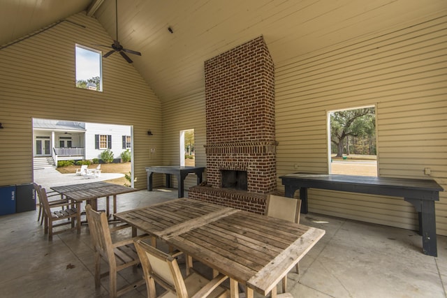 view of patio / terrace featuring an outdoor brick fireplace and ceiling fan