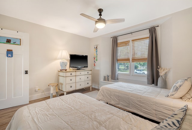 bedroom with hardwood / wood-style flooring and ceiling fan