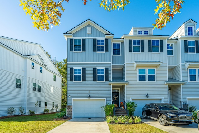 townhome / multi-family property featuring a front lawn and a garage