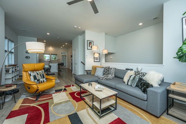 living room with hardwood / wood-style flooring and ceiling fan