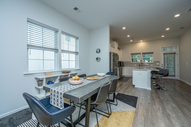 dining area with hardwood / wood-style floors and plenty of natural light