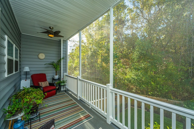 sunroom with ceiling fan and vaulted ceiling