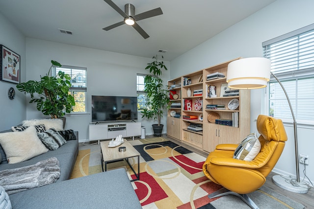 living room with hardwood / wood-style floors and ceiling fan