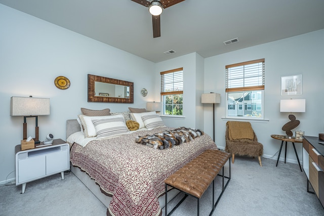 bedroom featuring light carpet and ceiling fan