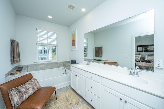 bathroom featuring vanity, tile patterned flooring, and a bathing tub