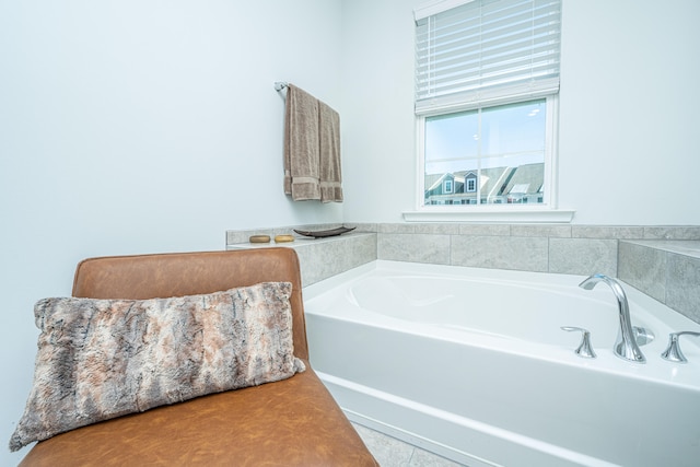 bathroom with a bath and tile patterned flooring